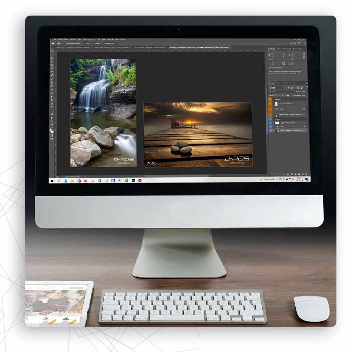 Monitor z programem graficznym i zdjęciami krajobrazu na jasnym biurku z klawiaturą
