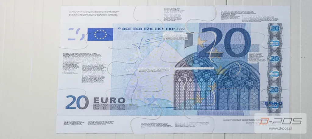 Banknot dwudziestoeurowy leżący na jasnym blacie