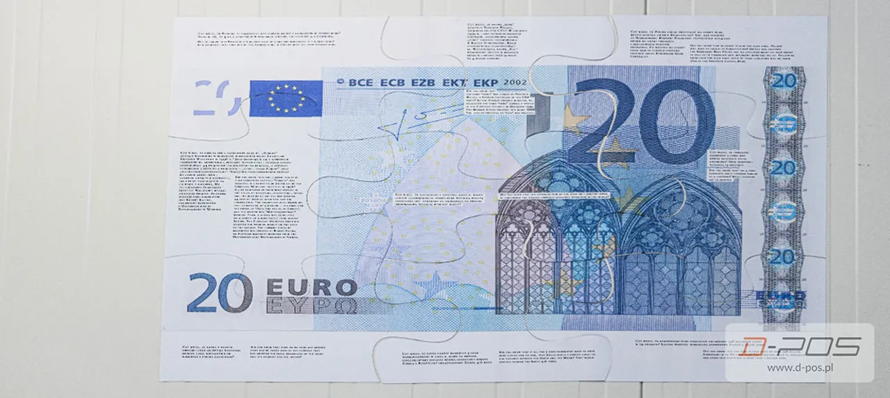 Banknot dwudziestoeurowy leżący na jasnym blacie
