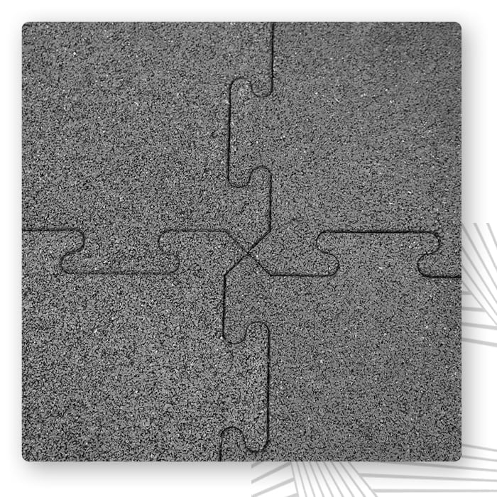 Cztery szare elementy w kształcie puzzli wycięte z płyty i złożone w kwadrat
